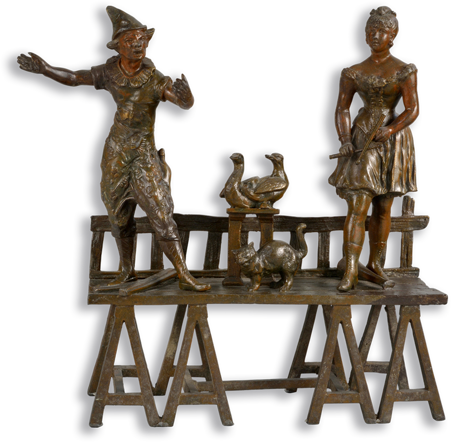 Bronze figurine of a man and woman on a stage with a cat and geese.